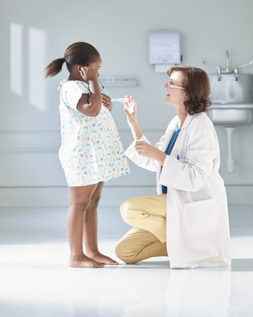 Girl listening to doctors stethoscope in hospital children’s ward thumbnail