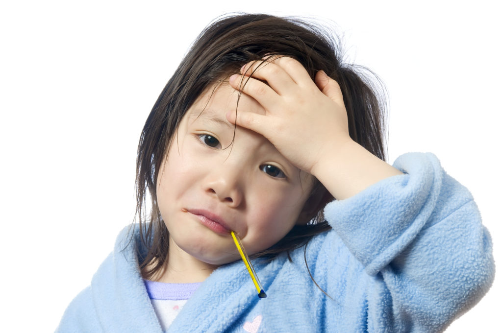 A young girl is sick and having her temperature taken. thumbnail